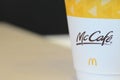 a McCafe coffee cup showcases the brand associated with McDonald\'s, known for