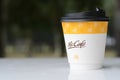 a McCafe coffee cup showcases the brand associated with McDonald\'s, known for