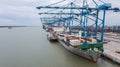 Klang, Malaysia - October 09, 2022: Cranes at the port Klang near Kuala Lumpur. Container crane at Klang Harbor. Aerial view on a Royalty Free Stock Photo