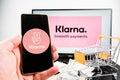 Klarna smooth payments logo on laptop and klarna company app logo on mobile phone.