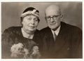 Vintage photo shows a married couple - silver wedding anniversary. Retro black and white studio photography.