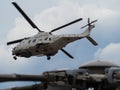 NH90 rescue helicopter of the Belgian navy in the background, with a close up of the rotor of a stationed helicopter in the foregr