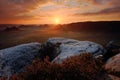 Kleiner Winterberg, beautiful morning view over sandstone cliff into deep misty valley in Saxony Switzerland, foggy background, th