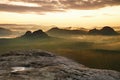 Kleiner Winterberg view. Fantastic dreamy sunrise on the top of the rocky mountain with the view into misty valley Royalty Free Stock Photo