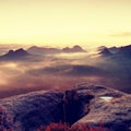 Kleiner Winterberg view. Fantastic dreamy sunrise on the top of the rocky mountain with the view into misty valley Royalty Free Stock Photo