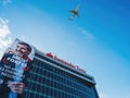 KLM plane flying above the Santander Totta bank headquarter building in Lisbon