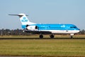 KLM Royal Dutch Airlines Fokker 70 PH-WXD passenger plane arrival and landing at Amsterdam Schipol Airport Royalty Free Stock Photo