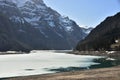 KlÃÂ¶ntalersee lake with layer of ice and panorama of Alps in background