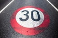 30km/h speed limit sign painted on asphalting road. Royalty Free Stock Photo