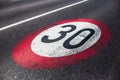 30km/h speed limit sign painted on asphalting road. Royalty Free Stock Photo