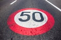 50km/h speed limit sign painted on asphalting road. Royalty Free Stock Photo