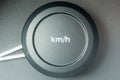 kmh lettering on a round plastic button. Car speedometer.