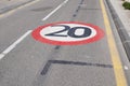 20 kmh speed limit 20mph car kph painted on street city on the town road Royalty Free Stock Photo