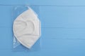 KN95 FPP2 medical respirator white mask medical equipment on blue wooden background