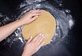 Knead the dough by female hands. Girl making a flaky pastry dough Royalty Free Stock Photo