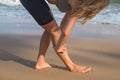 Kneading body muscles after jogging. Blond caucasian Girl massage her leg Royalty Free Stock Photo