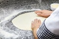 Kneading pizza dough.