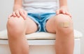 Knee with adhesive bandage. Royalty Free Stock Photo