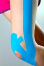 Knee with blue kinesio tape