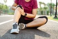 Knee Injuries. sport woman with strong athletic legs holding knee with her hands in pain after suffering muscle injury during a Royalty Free Stock Photo