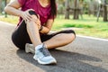 Knee Injuries. sport woman with strong athletic legs holding knee with her hands in pain after suffering muscle injury during a