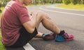 Knee Injuries. Young sport man holding knee with his hands in pain after suffering muscle injury during a running workout at park Royalty Free Stock Photo