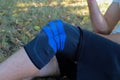 Knee injury in a brace. Orthopedic splint on a man`s leg