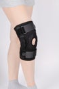 Knee Support Brace on leg isolated on white background. Elastic orthopedic orthosis. Anatomic braces for knee fixation Royalty Free Stock Photo