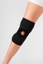 Knee Support Brace on leg isolated on white background. Elastic orthopedic orthosis. Anatomic braces for knee fixation Royalty Free Stock Photo