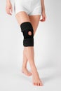 Knee Support Brace on leg isolated on white background. Elastic orthopedic orthosis. Anatomic braces for knee fixation Royalty Free Stock Photo