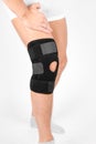 Knee Support Brace on leg isolated on white background. Elastic orthopedic orthosis. Anatomic braces for knee fixation Royalty Free Stock Photo