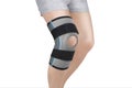 Knee Support Brace on leg isolated on white background. Orthopedic Anatomic Orthosis. Braces for knee fixation, injuries and pain. Royalty Free Stock Photo