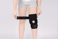 Knee Support Brace on leg  on white background. Elastic orthopedic orthosis. Anatomic braces for knee fixation Royalty Free Stock Photo
