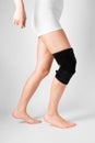 Knee Support Brace on leg  on white background. Elastic orthopedic orthosis. Anatomic braces for knee fixation Royalty Free Stock Photo