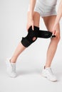 Knee Support Brace on leg  on white background. Elastic orthopedic orthosis. Anatomic braces for knee fixation Royalty Free Stock Photo