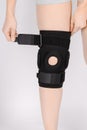 Knee Support Brace on leg  on white background. Elastic orthopedic orthosis. Anatomic braces for knee fixation Royalty Free Stock Photo