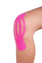 Knee treated with kinesio tape therapy Royalty Free Stock Photo