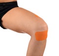 Knee treated with tape therapy Royalty Free Stock Photo