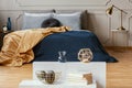 Knick knacks on console table in from of king size bed with comfortable bedding Royalty Free Stock Photo