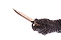 Knife in black glove isolated Royalty Free Stock Photo
