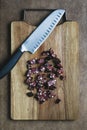 Knife and chopped sausage on a wooden chopping board. Food flat lay, top view. German traditional blutwurst in rustic style Royalty Free Stock Photo