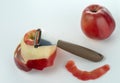 Knife for cleaning fruits and vegetables with the apple with peeled skin.