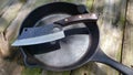 Knife cleaver and castiron skillet Royalty Free Stock Photo