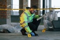 Knife clue. Detectives are collecting evidence in a crime scene near dead body. Forensic specialists are making expertise