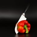Knife cut red bell pepper on the black background Royalty Free Stock Photo