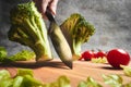 Knife cuts fresh cabbage on the board Royalty Free Stock Photo