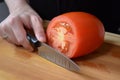 A knife cuts a tomato. AI Generated