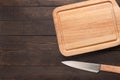 Knife and cutting board on the wooden background. Copy space for Royalty Free Stock Photo