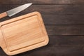 Knife and cutting board on the wooden background. Copy space for Royalty Free Stock Photo
