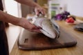 Knife cutting salmon, gutting fish in kitchen